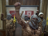 Islamic Revolutionary Guard Corps (IRGC) military personnel wear Palestinian scarves and uniforms, symbolizing Hamas warriors, and shout ant...