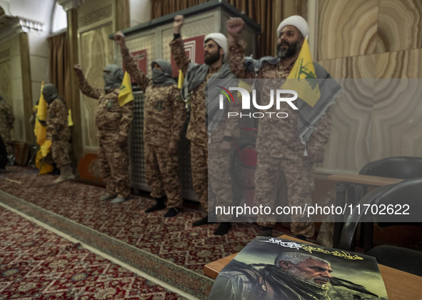 Islamic Revolutionary Guard Corps (IRGC) military personnel wear Palestinian scarves and uniforms, symbolizing Hamas warriors, and shout ant...