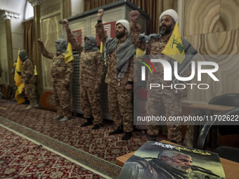 Islamic Revolutionary Guard Corps (IRGC) military personnel wear Palestinian scarves and uniforms, symbolizing Hamas warriors, and shout ant...