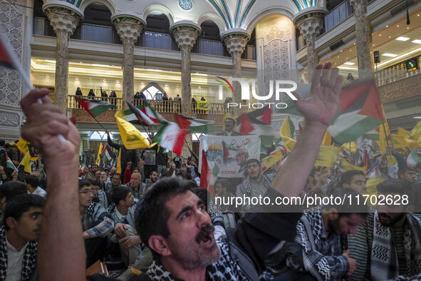 Iranian men shout anti-U.S. and anti-Israeli slogans while participating in a ceremony commemorating the killed Hamas Leader, Yahya Sinwar,...