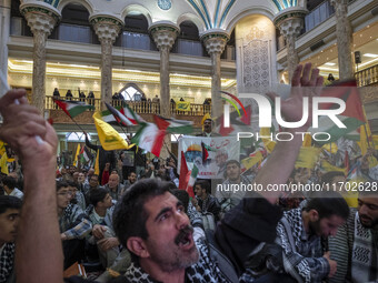 Iranian men shout anti-U.S. and anti-Israeli slogans while participating in a ceremony commemorating the killed Hamas Leader, Yahya Sinwar,...