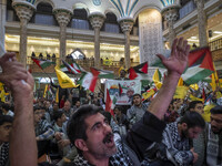 Iranian men shout anti-U.S. and anti-Israeli slogans while participating in a ceremony commemorating the killed Hamas Leader, Yahya Sinwar,...