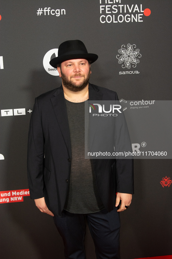 Marshall, a German actor, poses on the red carpet before the closing award ceremony of the Cologne Film Festival 2024 at E-Werk in Cologne,...