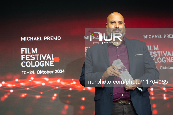 Michael Premo, a US filmmaker, receives the Phoenix Award during the closing award ceremony of the Cologne Film Festival 2024 at E-Werk in C...