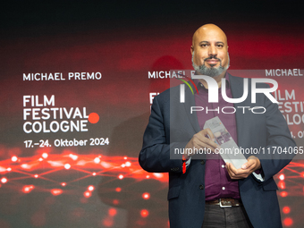 Michael Premo, a US filmmaker, receives the Phoenix Award during the closing award ceremony of the Cologne Film Festival 2024 at E-Werk in C...