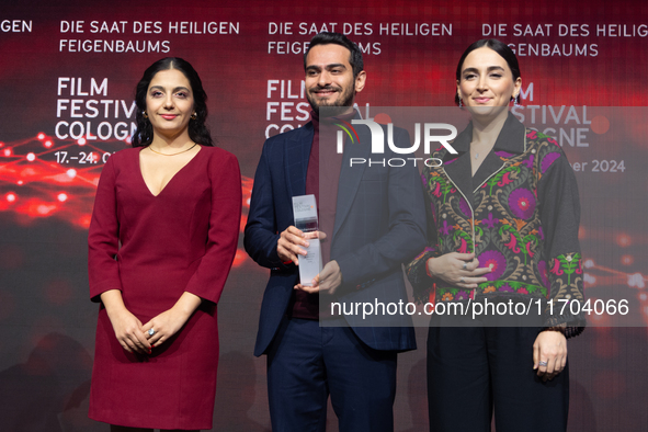 Amin Sadraei, Mahsa Rostami, and Setareh Maleki receive the Hollywood Reporter Award during the closing award ceremony of the Cologne Film F...