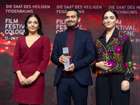 Amin Sadraei, Mahsa Rostami, and Setareh Maleki receive the Hollywood Reporter Award during the closing award ceremony of the Cologne Film F...