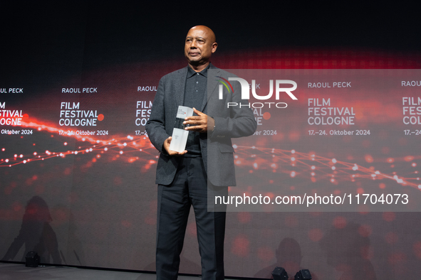 Raoul Peck, a Haitian filmmaker, receives the film prize award during the closing award ceremony of the Cologne Film Festival 2024 at E-Werk...