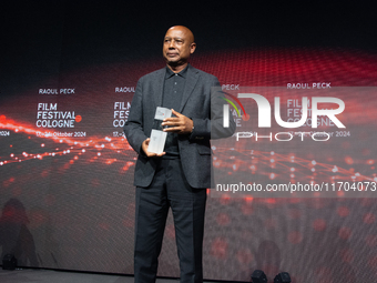 Raoul Peck, a Haitian filmmaker, receives the film prize award during the closing award ceremony of the Cologne Film Festival 2024 at E-Werk...