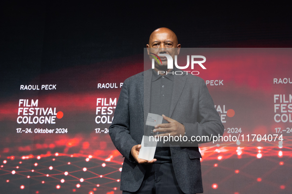 Raoul Peck, a Haitian filmmaker, receives the film prize award during the closing award ceremony of the Cologne Film Festival 2024 at E-Werk...