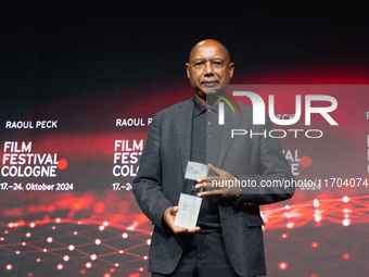 Raoul Peck, a Haitian filmmaker, receives the film prize award during the closing award ceremony of the Cologne Film Festival 2024 at E-Werk...