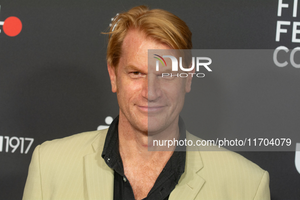 Enno Kalisch, a German actor, poses on the red carpet before the closing award ceremony of the Cologne Film Festival 2024 at E-Werk in Colog...