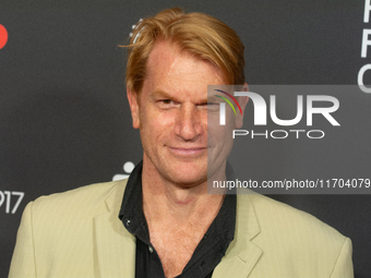 Enno Kalisch, a German actor, poses on the red carpet before the closing award ceremony of the Cologne Film Festival 2024 at E-Werk in Colog...