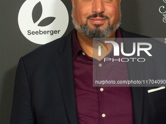 Michael Premo, a US filmmaker, poses on the red carpet before the closing award ceremony of the Cologne Film Festival 2024 at E-Werk in Colo...