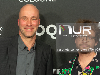 Sascha Verhey and Severin Fiala, a film director, pose on the red carpet before the closing award ceremony of the Cologne Film Festival 2024...