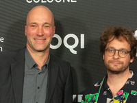 Sascha Verhey and Severin Fiala, a film director, pose on the red carpet before the closing award ceremony of the Cologne Film Festival 2024...