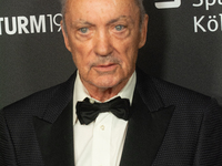 Udo Kier, a German actor, poses on the red carpet before the closing award ceremony of the Cologne Film Festival 2024 at E-Werk in Cologne,...