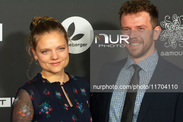 Aline Hochscheid, a German actress, and Dominik Flade, a German actor, pose on the red carpet before the closing award ceremony of the Colog...