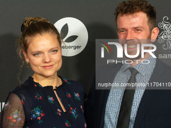 Aline Hochscheid, a German actress, and Dominik Flade, a German actor, pose on the red carpet before the closing award ceremony of the Colog...