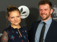 Aline Hochscheid, a German actress, and Dominik Flade, a German actor, pose on the red carpet before the closing award ceremony of the Colog...