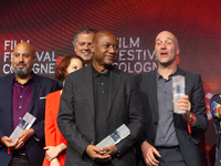 Raoul Peck, a Haitian filmmaker, and other prize winners take group pictures during the closing award ceremony of the Cologne Film Festival...