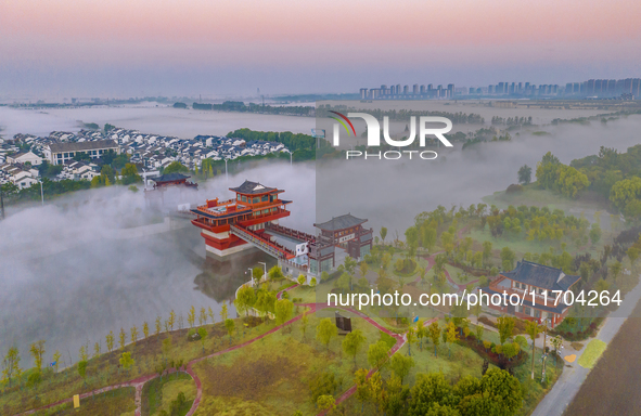 The Wafang Village is seen in the morning mist in Suqian, China, on October 24, 2024. In recent years, in combination with water environment...