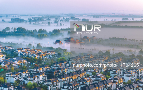 The Wafang Village is seen in the morning mist in Suqian, China, on October 24, 2024. In recent years, in combination with water environment...