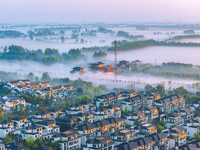 The Wafang Village is seen in the morning mist in Suqian, China, on October 24, 2024. In recent years, in combination with water environment...