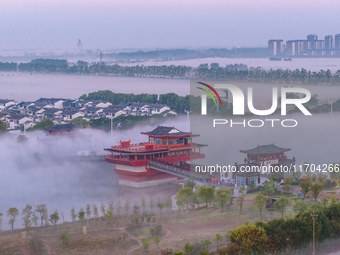 The Wafang Village is seen in the morning mist in Suqian, China, on October 24, 2024. In recent years, in combination with water environment...