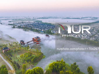 The Wafang Village is seen in the morning mist in Suqian, China, on October 24, 2024. In recent years, in combination with water environment...