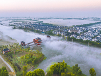 The Wafang Village is seen in the morning mist in Suqian, China, on October 24, 2024. In recent years, in combination with water environment...