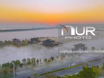 The Wafang Village is seen in the morning mist in Suqian, China, on October 24, 2024. In recent years, in combination with water environment...