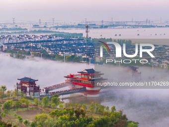 The Wafang Village is seen in the morning mist in Suqian, China, on October 24, 2024. In recent years, in combination with water environment...