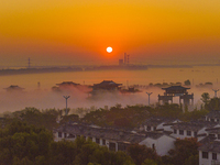 The Wafang Village is seen in the morning mist in Suqian, China, on October 24, 2024. In recent years, in combination with water environment...