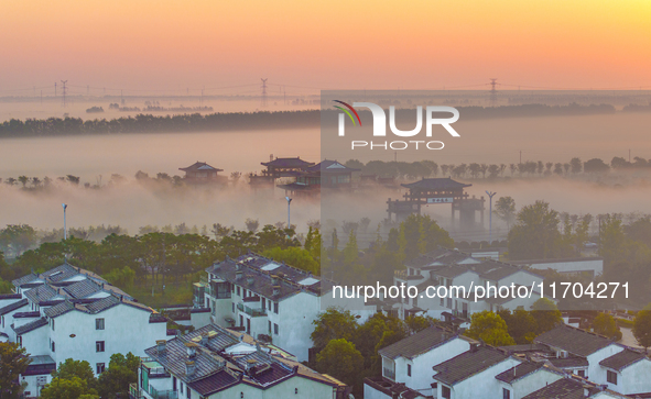 The Wafang Village is seen in the morning mist in Suqian, China, on October 24, 2024. In recent years, in combination with water environment...