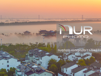 The Wafang Village is seen in the morning mist in Suqian, China, on October 24, 2024. In recent years, in combination with water environment...