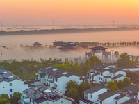 The Wafang Village is seen in the morning mist in Suqian, China, on October 24, 2024. In recent years, in combination with water environment...