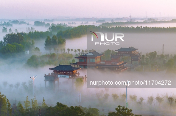 The Wafang Village is seen in the morning mist in Suqian, China, on October 24, 2024. In recent years, in combination with water environment...