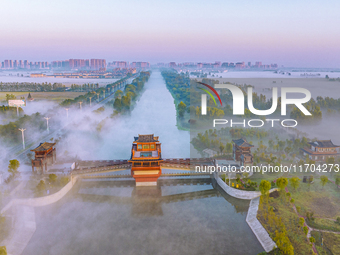 The Wafang Village is seen in the morning mist in Suqian, China, on October 24, 2024. In recent years, in combination with water environment...