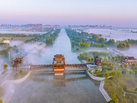 The Wafang Village is seen in the morning mist in Suqian, China, on October 24, 2024. In recent years, in combination with water environment...