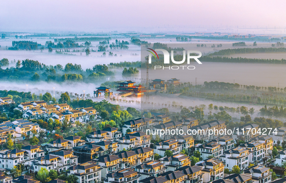 The Wafang Village is seen in the morning mist in Suqian, China, on October 24, 2024. In recent years, in combination with water environment...