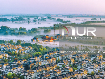 The Wafang Village is seen in the morning mist in Suqian, China, on October 24, 2024. In recent years, in combination with water environment...