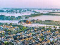 The Wafang Village is seen in the morning mist in Suqian, China, on October 24, 2024. In recent years, in combination with water environment...