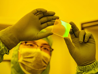 A researcher checks grating substrates in the yellow light detection room at the research building of Anhui Zhongke Grating Technology Co.,...