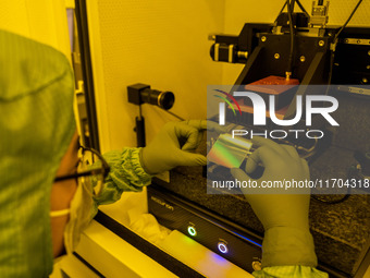 A researcher conducts a grating groove depth test in the yellow light detection room at the research building of Anhui Zhongke Grating Techn...