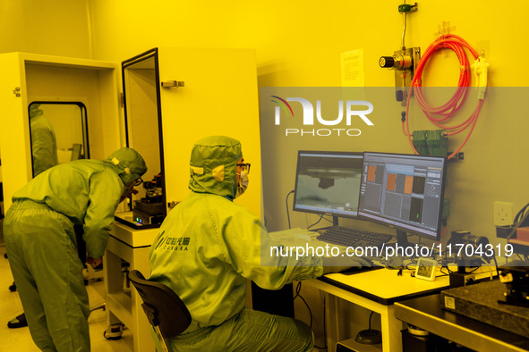 A researcher conducts a grating groove depth test in the yellow light detection room at the research building of Anhui Zhongke Grating Techn...