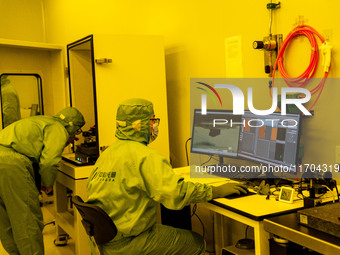 A researcher conducts a grating groove depth test in the yellow light detection room at the research building of Anhui Zhongke Grating Techn...