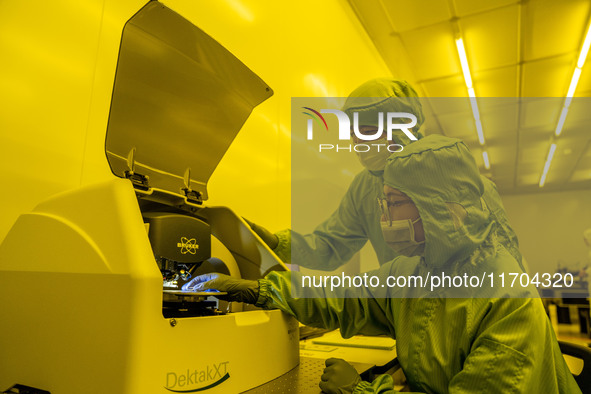 A researcher conducts a grating groove depth test in the yellow light detection room at the research building of Anhui Zhongke Grating Techn...