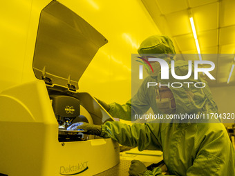 A researcher conducts a grating groove depth test in the yellow light detection room at the research building of Anhui Zhongke Grating Techn...