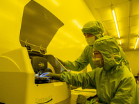 A researcher conducts a grating groove depth test in the yellow light detection room at the research building of Anhui Zhongke Grating Techn...